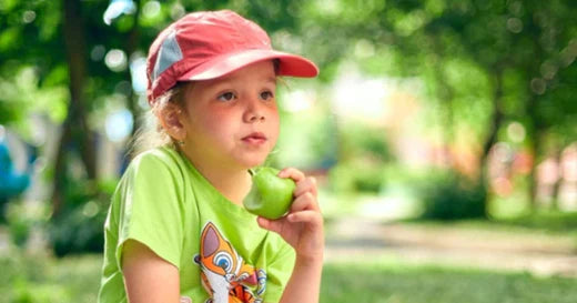 child eating apple