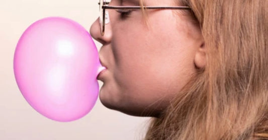girl blowing bubble gum