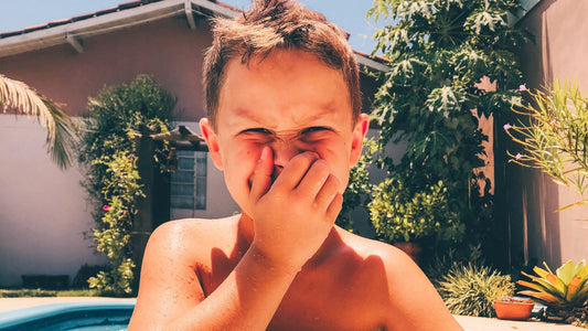 kid pinching his nose