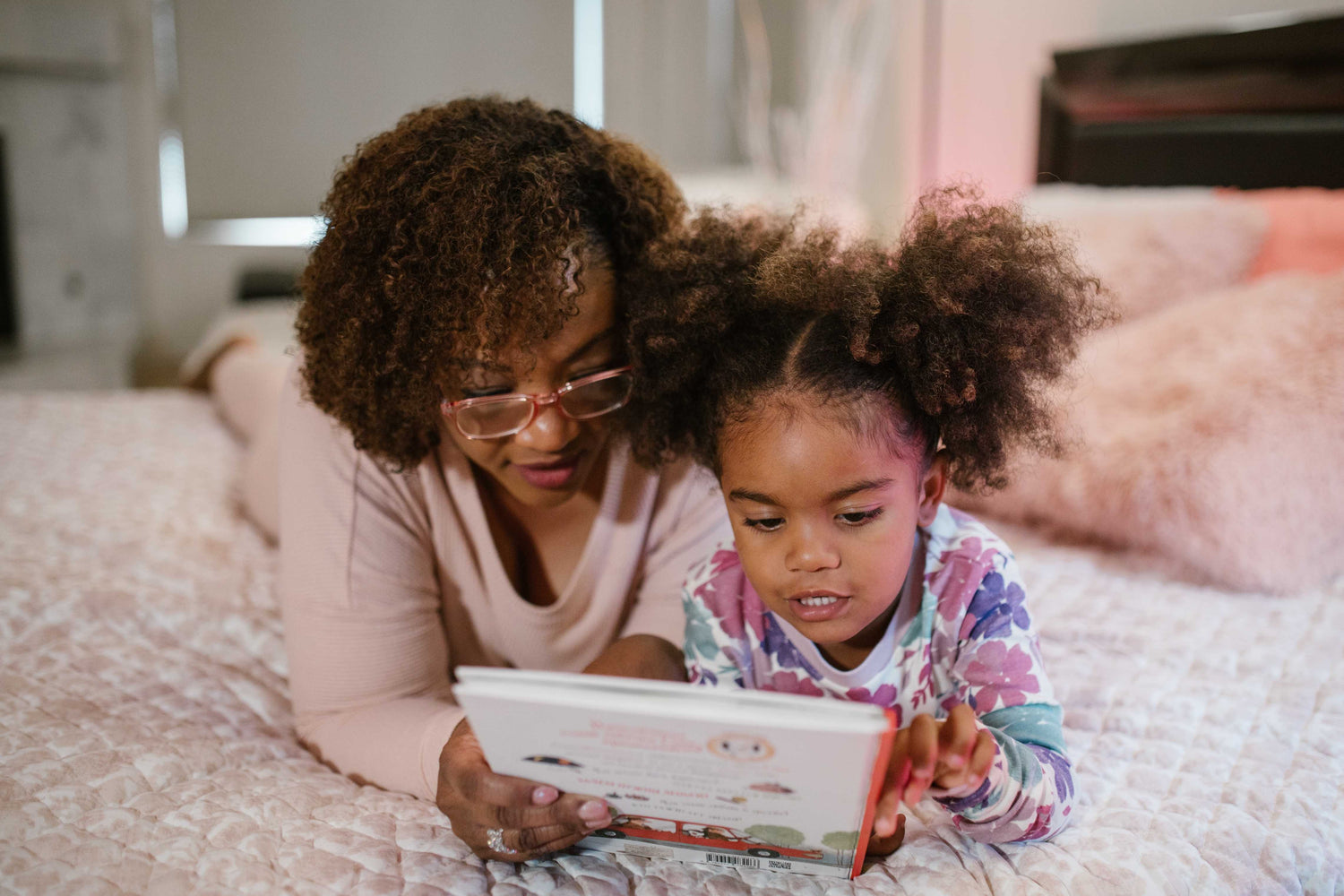 mom and daughter reading book